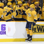 
              Nashville Predators center Juuso Parssinen (75) is congratulated after scoring a goal against the Calgary Flames during the first period of an NHL hockey game, Monday, Jan. 16, 2023, in Nashville, Tenn. (AP Photo/Mark Zaleski)
            