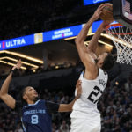 
              Minnesota Timberwolves center Rudy Gobert (27) dunks against Memphis Grizzlies forward Ziaire Williams (8) during the second half of an NBA basketball game, Friday, Jan. 27, 2023, in Minneapolis. (AP Photo/Abbie Parr)
            
