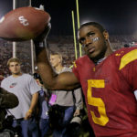
              FILE - Southern California tail back Reggie Bush walks off the field holding the game ball after the Trojans defeated Fresno State, 50-42, at the Los Angeles Coliseum on Nov. 19, 2005. Reggie Bush, whose Heisman Trophy victory for Southern California in 2005 was vacated because of NCAA violations, was among 18 players in the latest College Football Hall of Fame class announced Monday, Jan. 9, 2023. (AP Photo/Kevork Djansezian, File)
            