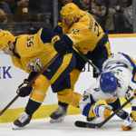 
              Nashville Predators defenseman Roland McKeown (55) gets control of the puck in front of right wing Nino Niederreiter (22) and Buffalo Sabres center Dylan Cozens (24) during the first period of an NHL hockey game Saturday, Jan. 14, 2023, in Nashville, Tenn. (AP Photo/Mark Zaleski)
            