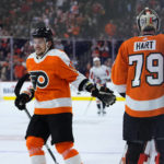
              Philadelphia Flyers' Travis Konecny, left, and Carter Hart celebrate after a goal by Konecny during the first period of an NHL hockey game against the Washington Capitals, Wednesday, Jan. 11, 2023, in Philadelphia. (AP Photo/Matt Slocum)
            