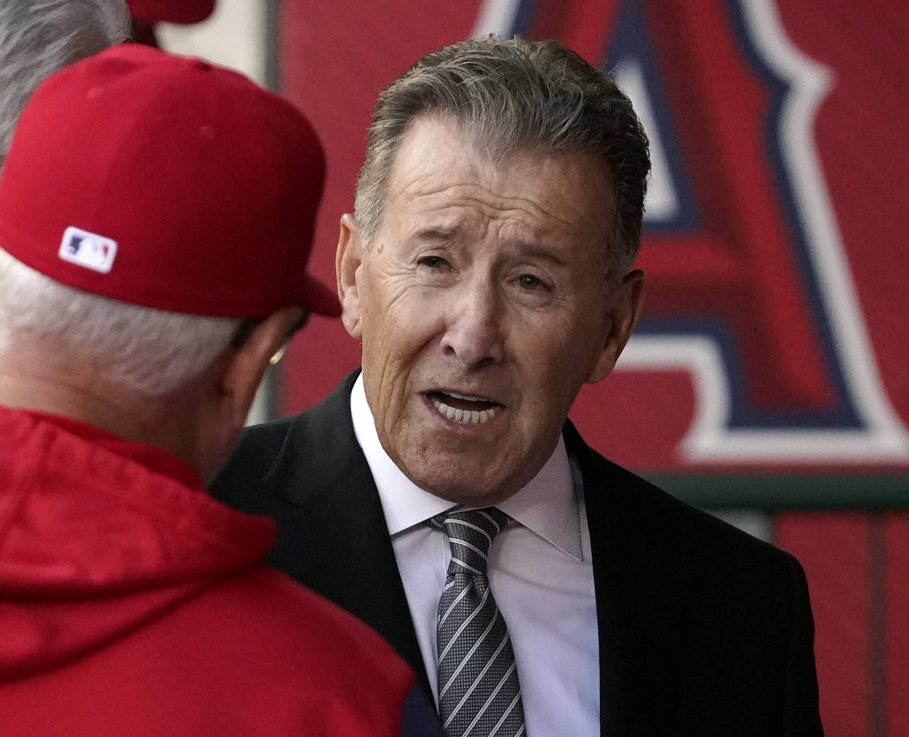 FILE - Los Angeles Angels owner Arte Moreno, right, talks with Angels manager Joe Maddon prior to a...
