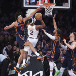 
              Phoenix Suns forward Josh Okogie (2) drives to the basket against New York Knicks center Jericho Sims (45), guard Jalen Brunson, second from right, and center Isaiah Hartenstein, right, during the first half of an NBA basketball game, Monday, Jan. 2, 2023, in New York. (AP Photo/Jessie Alcheh)
            