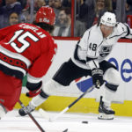 
              Los Angeles Kings' Brendan Lemieux (48) moves the puck from Carolina Hurricanes' Dylan Coghlan (15) during the first period of an NHL hockey game in Raleigh, N.C., Tuesday, Jan. 31, 2023. (AP Photo/Karl B DeBlaker)
            