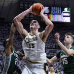
              Purdue center Zach Edey (15) shoots between Michigan State guard Tyson Walker (2) and center Carson Cooper (15) during the second half of an NCAA college basketball game in West Lafayette, Ind., Sunday, Jan. 29, 2023. Purdue defeated Michigan State 77-61. (AP Photo/Michael Conroy)
            