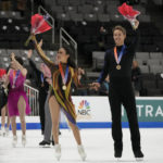 
              Madison Chock, center left, and Evan Bates wave after finishing first during the free dance at the U.S. figure skating championships in San Jose, Calif., Saturday, Jan. 28, 2023. (AP Photo/Tony Avelar)
            