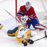 
              Nashville Predators' Cole Smith (36) falls to the ice as Montreal Canadiens goaltender Sam Montembeault (35) makes a stop during third-period NHL hockey game action in Montreal, Thursday, Jan. 12, 2023. (Paul Chiasson/The Canadian Press via AP)
            