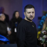 
              Ukrainian President Volodymyr Zelenskyy pays his respects to victims of a deadly helicopter crash during a farewell ceremony in Kyiv, Ukraine, Saturday, Jan. 21, 2023. Interior Minister Denys Monastyrsky, his Deputy Yevhen Yenin, State Secretary Yurii Lubkovych, national police official and the three crew members were killed in a helicopter crash on Wednesday in Kyiv suburbs of Brovary. (AP Photo/Efrem Lukatsky)
            