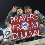 
              Fans display a sign honoring injured Buffalo Bills player Damar Hamlin before an NFL football game between the Jacksonville Jaguars and the Tennessee Titans, Saturday, Jan. 7, 2023, in Jacksonville, Fla. (AP Photo/Phelan M. Ebenhack)
            