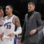 
              Washington Wizards center Kristaps Porzingis wears a suit while standing at the bench with forward Kyle Kuzma (33) and other teammates during the first half of an NBA basketball game against the Dallas Mavericks in Dallas, Tuesday, Jan. 24, 2023. (AP Photo/LM Otero)
            