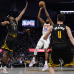 
              Phoenix Suns guard Mikal Bridges (25) shoots over Golden State Warriors center Kevon Looney (5) during the second half of an NBA basketball game in San Francisco, Tuesday, Jan. 10, 2023. (AP Photo/Godofredo A. Vásquez)
            