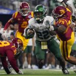 
              Tulane running back Tyjae Spears (22) runs with the ball during the second half of the Cotton Bowl NCAA college football game against Southern California, Monday, Jan. 2, 2023, in Arlington, Texas. (AP Photo/Sam Hodde)
            