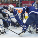 
              Toronto Maple Leafs goaltender Ilya Samsonov (35) makes a save as Winnipeg Jets left wing Pierre-Luc Dubois (80) and Maple Leafs defenseman Justin Holl (3) battle for the rebound during the first period of an NHL hockey game, Thursday, Jan. 19, 2023 in Toronto. (Nathan Denette/The Canadian Press via AP)
            
