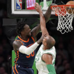 
              New York Knicks forward Julius Randle (30) drives to the basket to score as Boston Celtics center Al Horford, right, defends during the first half of an NBA basketball game Thursday, Jan. 26, 2023, in Boston. (AP Photo/Steven Senne)
            