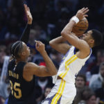 
              Golden State Warriors guard Jordan Poole shoots against Cleveland Cavaliers forward Isaac Okoro (35) during the first half of an NBA basketball game Friday, Jan. 20, 2023, in Cleveland. (AP Photo/Ron Schwane)
            