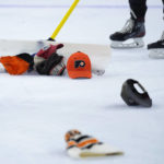 
              Workers clear hats from the ice after a third goal by Philadelphia Flyers' Travis Konecny during an NHL hockey game against the Washington Capitals, Wednesday, Jan. 11, 2023, in Philadelphia. (AP Photo/Matt Slocum)
            