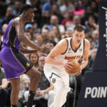 
              Denver Nuggets center Nikola Jokic, right, pulls in the ball as Los Angeles Lakers center Thomas Bryant defends in the first half of an NBA basketball game Monday, Jan. 9, 2023, in Denver. (AP Photo/David Zalubowski)
            