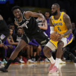 
              Sacramento Kings forward Chimezie Metu (7) defends against Los Angeles Lakers forward LeBron James (6) during the second half of an NBA basketball game in Los Angeles, Wednesday, Jan. 18, 2023. (AP Photo/Ashley Landis)
            