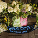 
              Flowers and a Charlotte Football Club scarf are shown outside Bank of America Stadium in Charlotte, N.C., Thursday, Jan. 19, 2023. Charlotte FC soccer player Anton Walkes has died from injuries he sustained in a boat crash off the coast of Miami, authorities said Thursday. (AP Photo/Nell Redmond)
            