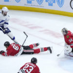 
              Chicago Blackhawks' Caleb Jones (82) blocks the shot of Tampa Bay Lightning's Victor Hedman as goaltender Alex Stalock also defends during the first period of an NHL hockey game Tuesday, Jan. 3, 2023, in Chicago. (AP Photo/Charles Rex Arbogast)
            