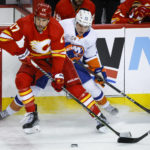 
              New York Islanders defenseman Sebastian Aho, right, is checked by Calgary Flames forward Milan Lucic during the first period of an NHL hockey game Friday, Jan. 6, 2023, in Calgary, Alberta. (Jeff McIntosh/The Canadian Press via AP)
            