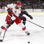 
              Carolina Hurricanes defenseman Jaccob Slavin, left, reaches for the puck in front of Columbus Blue Jackets forward Sean Kuraly during the second period of an NHL hockey game in Columbus, Ohio, Thursday, Jan. 12, 2023. (AP Photo/Paul Vernon)
            