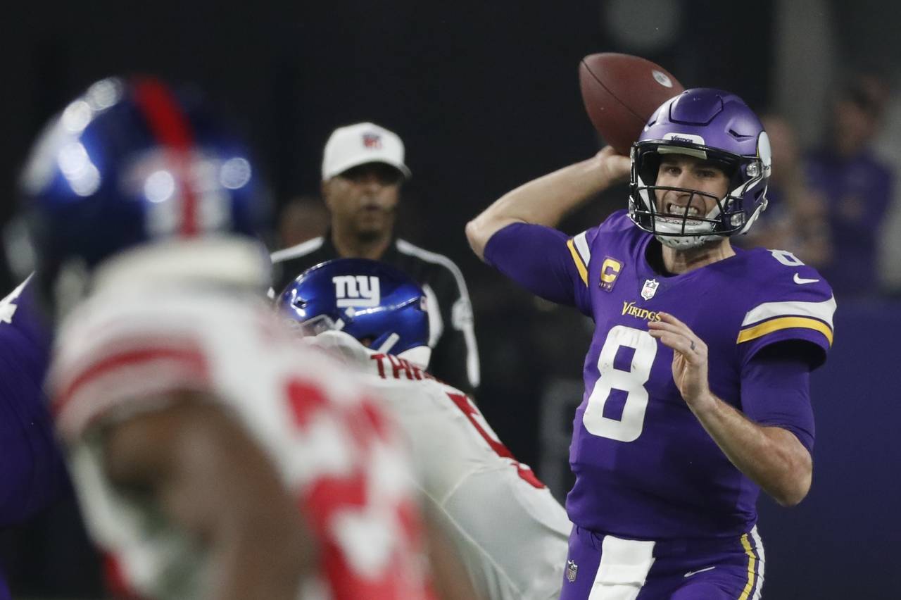 Minnesota Vikings' Kirk Cousins thorws during the second half of an NFL wild card football game aga...