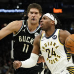 
              Indiana Pacers' Buddy Hield drives to the basket against Milwaukee Bucks' Brook Lopez during the first half of an NBA basketball game, Monday, Jan. 16, 2023, in Milwaukee. (AP Photo/Aaron Gash)
            