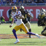 
              LSU quarterback Jayden Daniels (5) scrambles for a 35-yard run past the Purdue defense including safety Antonio Stevens (35) during the first half of the Citrus Bowl NCAA college football game Monday, Jan. 2, 2023, in Orlando, Fla. (AP Photo/John Raoux)
            