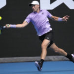 
              Casper Ruud of Norway plays a forehand return to Jenson Brooksby of the U.S. during their second round match at the Australian Open tennis championship in Melbourne, Australia, Thursday, Jan. 19, 2023. (AP Photo/Dita Alangkara)
            
