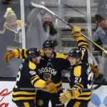 
              Boston Bruins' A.J. Greer (10) celebrates his goal against the Toronto Maple Leafs with Tomas Nosek (92) and Hampus Lindholm (27) during the second period of an NHL hockey game Saturday, Jan. 14 2023, in Boston. (AP Photo/Michael Dwyer)
            