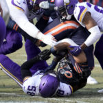 
              Chicago Bears running back David Montgomery, center, is tackled by Minnesota Vikings linebacker Jordan Hicks (58) during the first half of an NFL football game, Sunday, Jan. 8, 2023, in Chicago. (AP Photo/Charles Rex Arbogast)
            