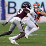 
              Illinois wide receiver Casey Washington (14) tries to get around Mississippi State cornerback Emmanuel Forbes after a catch during the first half of the ReliaQuest Bowl NCAA college football game Monday, Jan. 2, 2023, in Tampa, Fla. (AP Photo/Chris O'Meara)
            