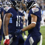 
              Tennessee Titans wide receiver Robert Woods (2) celebrates his touchdown with Treylon Burks (16) during the second half of an NFL football game against the Dallas Cowboys, Thursday, Dec. 29, 2022, in Nashville, Tenn. (AP Photo/Mark Zaleski)
            