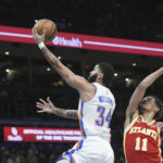 
              Oklahoma City Thunder forward Kenrich Williams (34) goes up for a shot past Atlanta Hawks guard Trae Young (11) in the second half of an NBA basketball game, Wednesday, Jan. 25, 2023, in Oklahoma City. (AP Photo/Kyle Phillips)
            