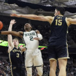 
              Michigan State guard Tyson Walker (2) attempts a layup as Purdue center Zach Edey (15) defends during the second half of an NCAA college basketball game, Monday, Jan. 16, 2023, in East Lansing, Mich. (AP Photo/Carlos Osorio)
            