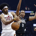 
              Cleveland Cavaliers center Jarrett Allen grabs a rebound against Los Angeles Clippers center Moses Brown (9) during the first half of an NBA basketball game, Sunday, Jan. 29, 2023, in Cleveland. (AP Photo/Ron Schwane)
            