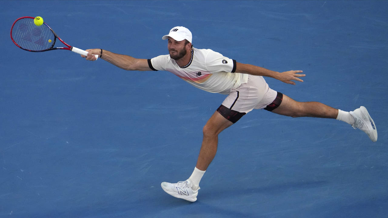Tommy Paul of the U.S. plays a forehand return to Novak Djokovic of Serbia during their semifinal a...