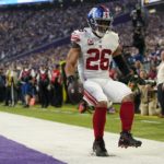 
              New York Giants' Saquon Barkley runs for a touchdown during the first half of an NFL wild card football game against the Minnesota Vikings Sunday, Jan. 15, 2023, in Minneapolis. (AP Photo/Abbie Parr)
            