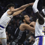 
              Los Angeles Lakers guard Max Christie (10) and forward Wenyen Gabriel (35) defend against Sacramento Kings forward Trey Lyles (41) during the first quarter of an NBA basketball game in Sacramento, Calif., Saturday, Jan. 7, 2023. (AP Photo/José Luis Villegas)
            