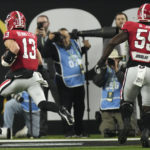 
              Georgia quarterback Stetson Bennett (13) runs into the end zone for a touchdown against TCU during the first half of the national championship NCAA College Football Playoff game, Monday, Jan. 9, 2023, in Inglewood, Calif. (AP Photo/Mark J. Terrill)
            