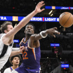 
              Phoenix Suns' Deandre Ayton (22) and San Antonio Spurs' Jakob Poeltl, left, grab for a rebound during the first half of an NBA basketball game, Saturday, Jan. 28, 2023, in San Antonio. (AP Photo/Darren Abate)
            