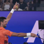 
              Serbia's Novak Djokovic gestures during an exhibition match against Australia's Nick Kyrgios on Rod Laver Arena ahead of the Australian Open tennis championship in Melbourne, Australia, Friday, Jan. 13, 2023. (AP Photo/Mark Baker)
            