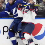 
              Tampa Bay Lightning left wing Pat Maroon (14) checks Columbus Blue Jackets defenseman Gavin Bayreuther (15) into the boards during the second period of an NHL hockey game Tuesday, Jan. 10, 2023, in Tampa, Fla. (AP Photo/Chris O'Meara)
            