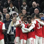 
              Arsenal players celebrate after scoring during the English Premier League soccer match between Tottenham Hotspur and Arsenal at the Tottenham Hotspur Stadium in London, England, Sunday, Jan. 15, 2023. (AP Photo/Frank Augstein)
            