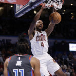 
              Cleveland Cavaliers forward Evan Mobley dunks in front of Oklahoma City Thunder guard Isaiah Joe during the first half of an NBA basketball game Friday, Jan. 27, 2023, in Oklahoma City. (AP Photo/Nate Billings)
            
