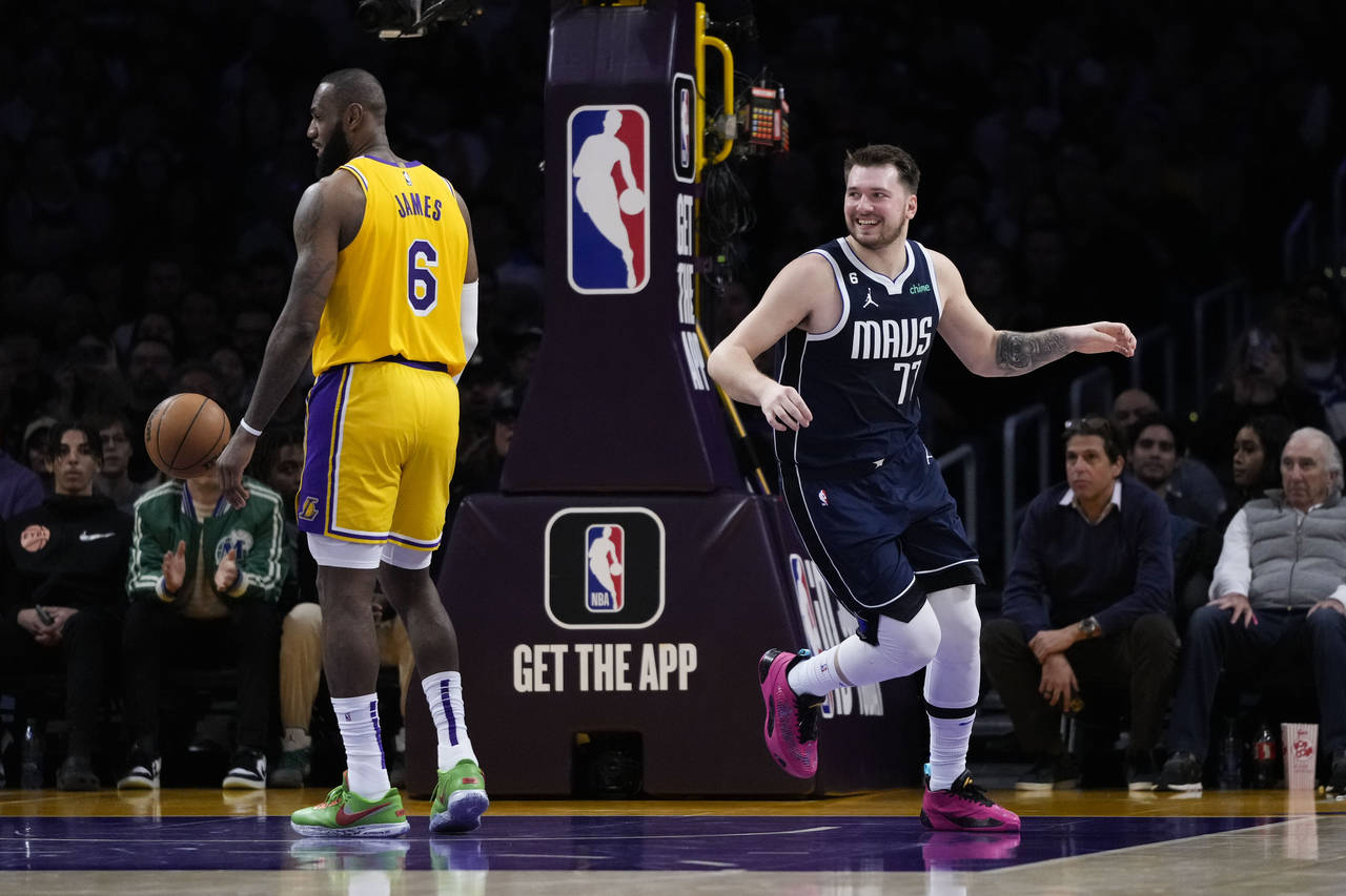 Dallas Mavericks' Luka Doncic (77) smiles after making a basket against Los Angeles Lakers' LeBron ...