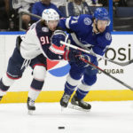 
              Tampa Bay Lightning center Anthony Cirelli (71) and Columbus Blue Jackets center Kent Johnson (91) fight for a loose puck during the first period of an NHL hockey game Tuesday, Jan. 10, 2023, in Tampa, Fla. (AP Photo/Chris O'Meara)
            
