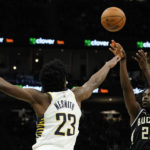 
              Milwaukee Bucks' Jrue Holiday (21) shoots against Indiana Pacers' Aaron Nesmith (23) during the second half of an NBA basketball game, Monday, Jan. 16, 2023, in Milwaukee. (AP Photo/Aaron Gash)
            