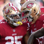 
              San Francisco 49ers running back Elijah Mitchell, left, celebrates with tight end George Kittle after scoring against the Arizona Cardinals during the first half of an NFL football game in Santa Clara, Calif., Sunday, Jan. 8, 2023. (AP Photo/Godofredo A. Vásquez)
            